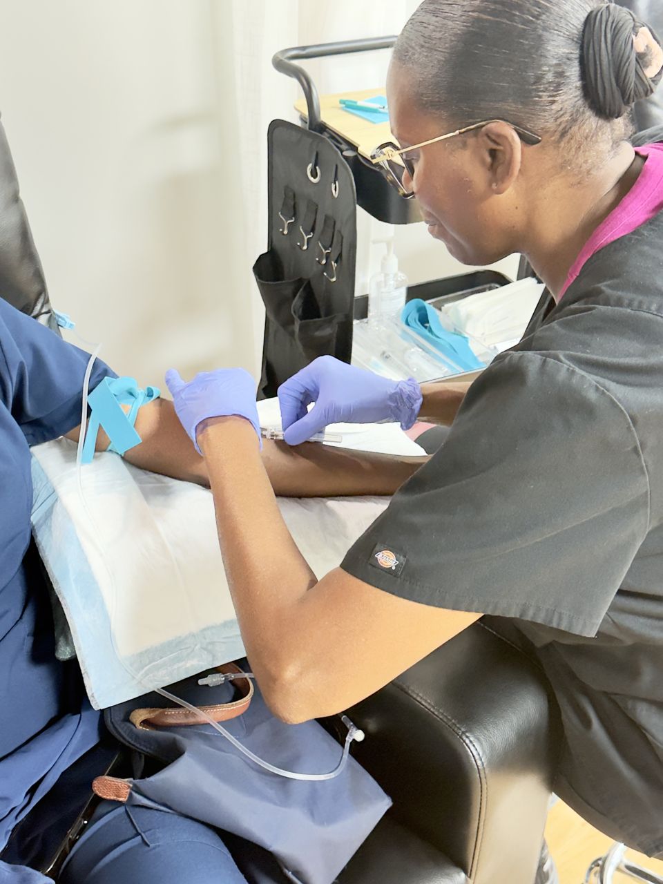Staff member preparing an IV treatment for a client at LIVE Hydration Spa Cary